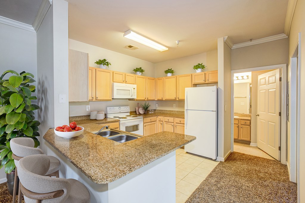 a kitchen with a granite counter top at Village on the Lake Apartments, Spring Lake, North Carolina